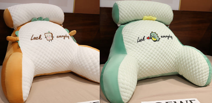 Two views of a cartoon character pillow with text on a wooden surface.
