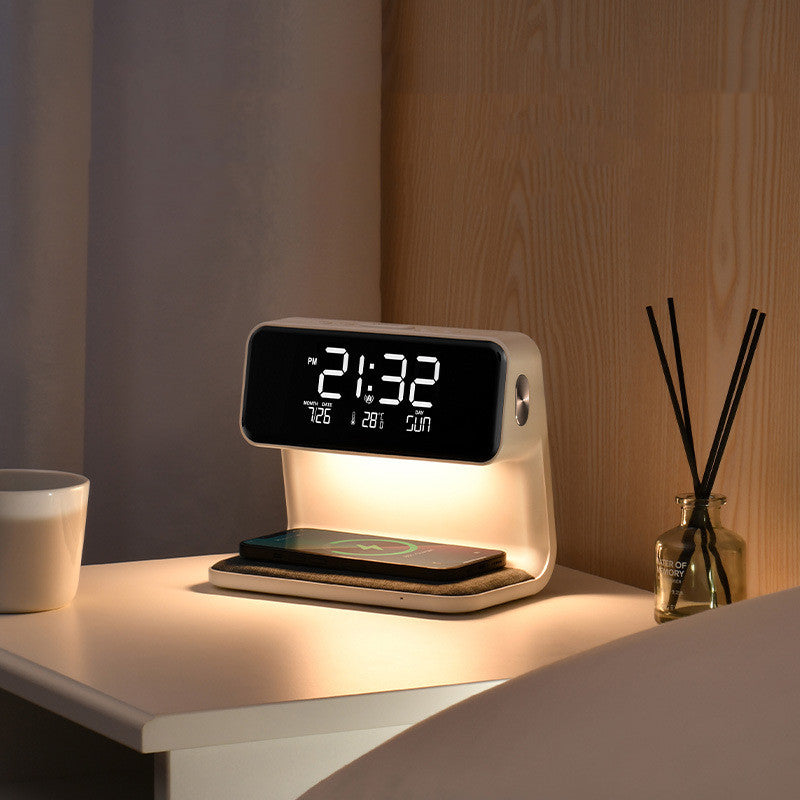 Digital clock with wireless charging pad on a nightstand