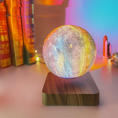 Colorful moon lamp on a wooden base with books and decorative items in the background