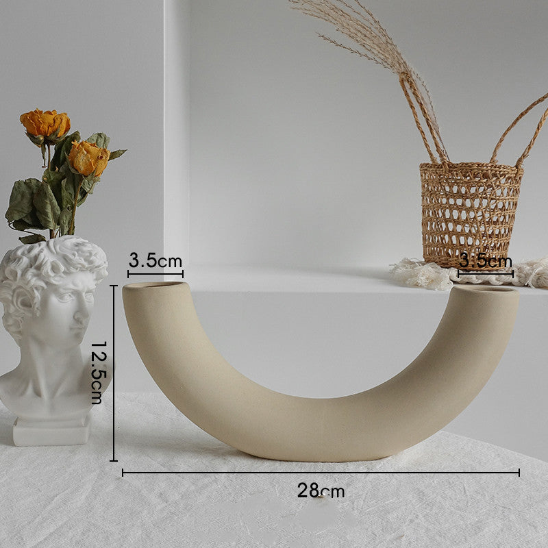 Beige curved decorative item with measurements on a neutral background