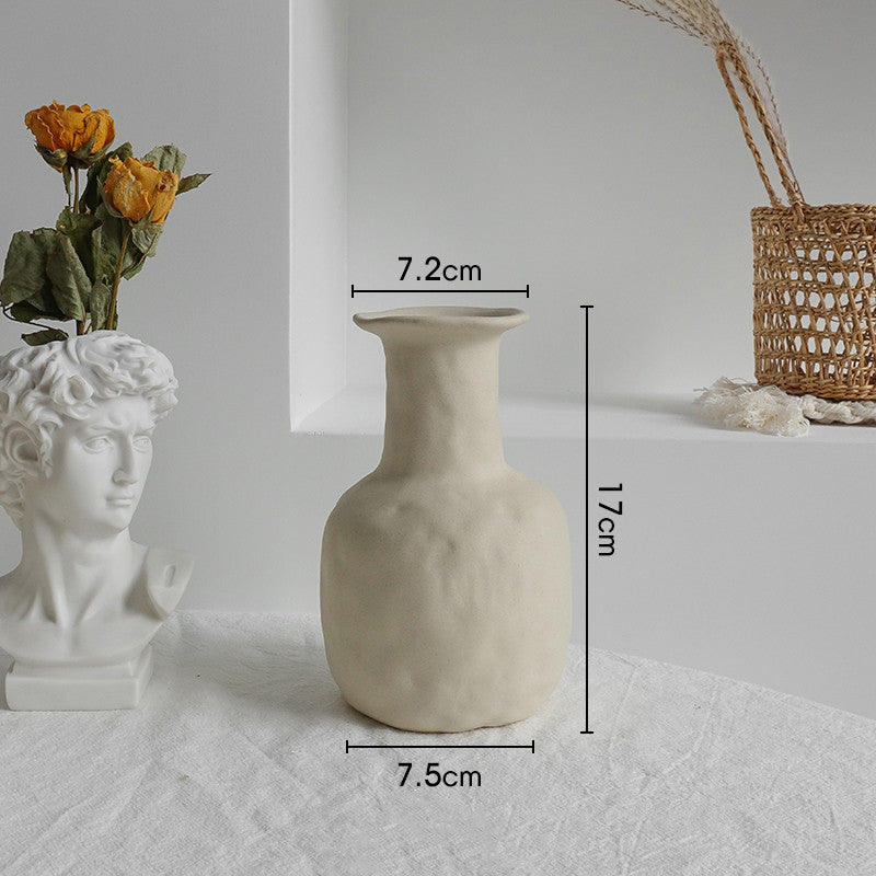 White textured vase with measurements on a light gray surface