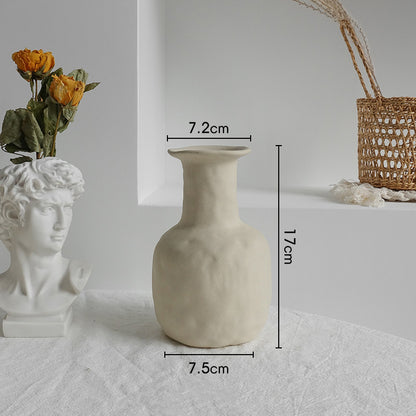 White textured vase with measurements on a light gray surface