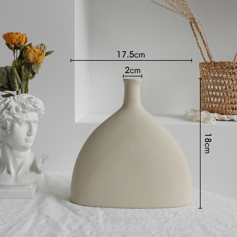 Beige ceramic vase with measurements on a neutral background