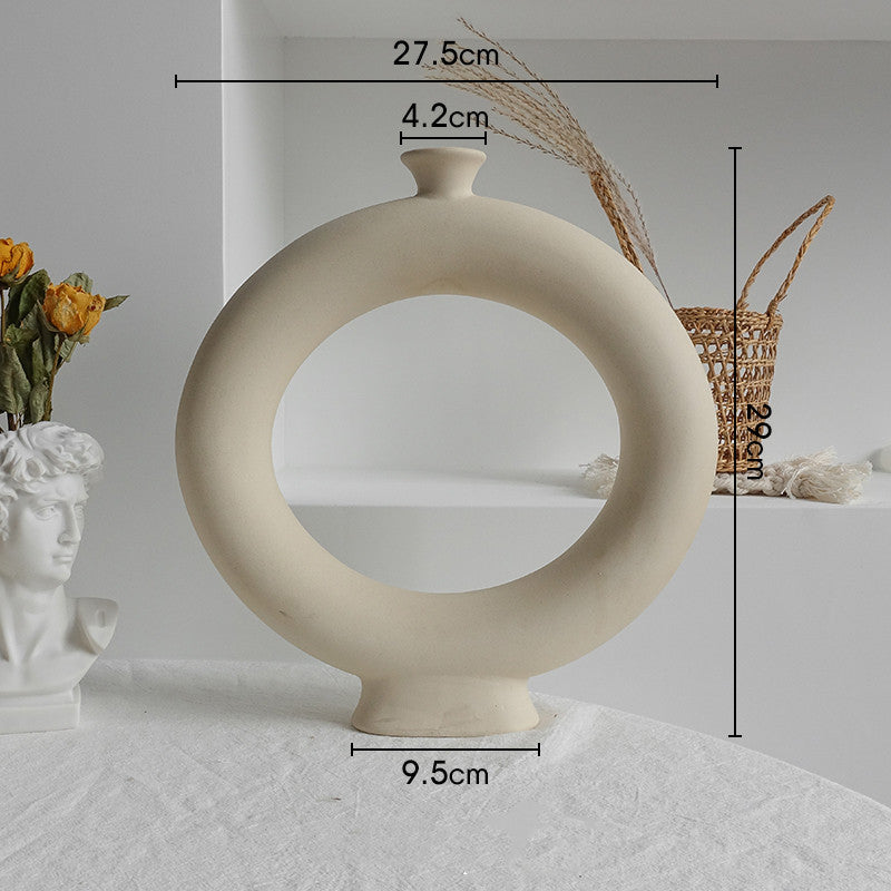 Beige circular vase with measurements on a light gray background