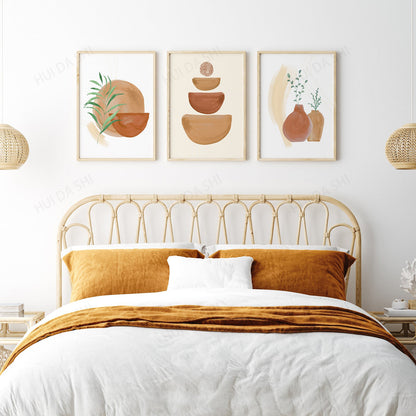 Bedroom with a gold headboard, white bedding, and orange pillows with wall art featuring terracotta pots and plants.