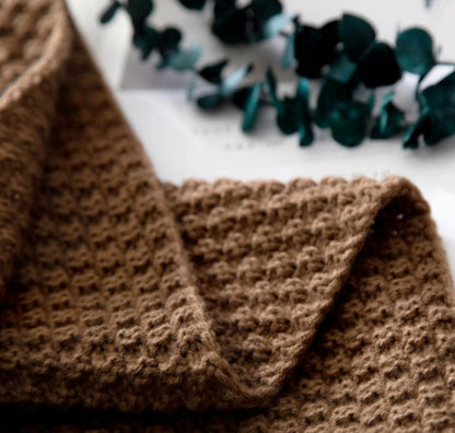 Brown textured fabric with decorative elements on a white background