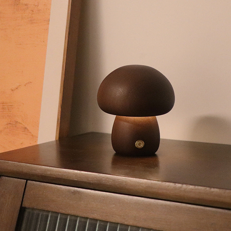 Mushroom-shaped lamp on a wooden surface with a warm glow