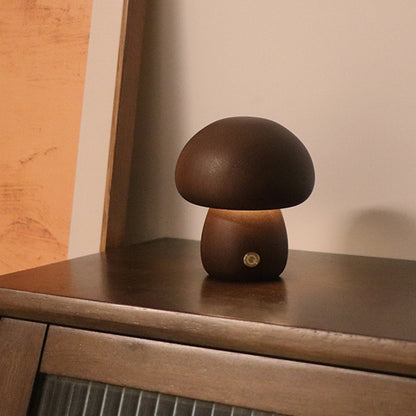 Mushroom-shaped lamp on a wooden surface with a warm glow