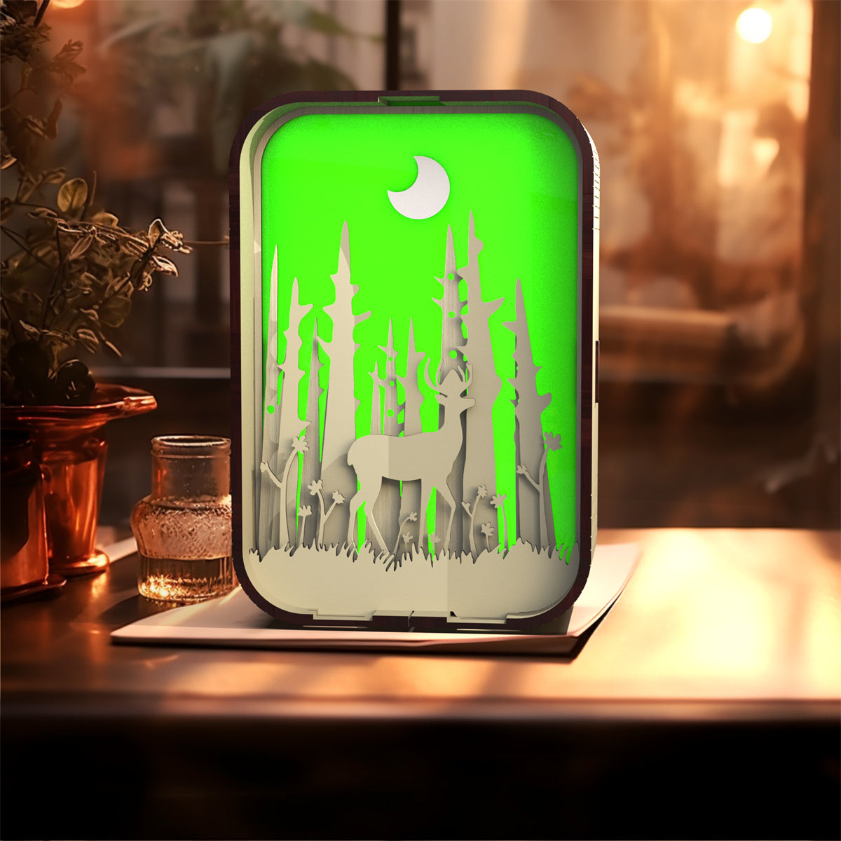 Decorative night light with deer design on a wooden surface
