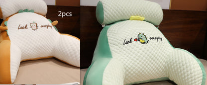 Two plush pillows with cartoon character designs on a brown surface.