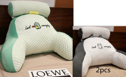 Two ergonomic backrest pillows with cartoon character design on a Loewe surface.