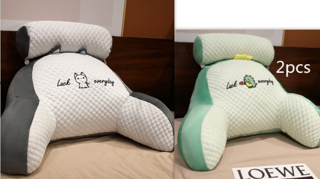 Two ergonomic pillows with text and branding on a bed.