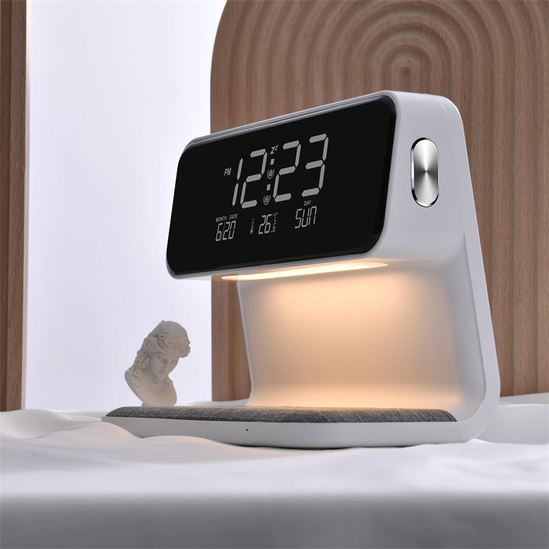 Digital clock with lamp on a bed