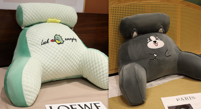 Two cartoon-themed headrests, one green and one gray, on a surface with visible brand names.