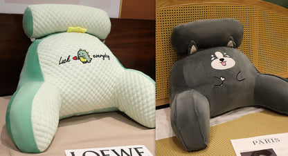 Two cartoon-themed headrests, one green and one gray, on a surface with visible brand names.