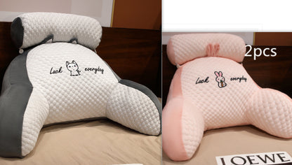 Two car headrest pillows, one gray and one pink, with text on a brown surface.