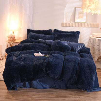 Navy blue fluffy comforter set on a bed in a bedroom setting.