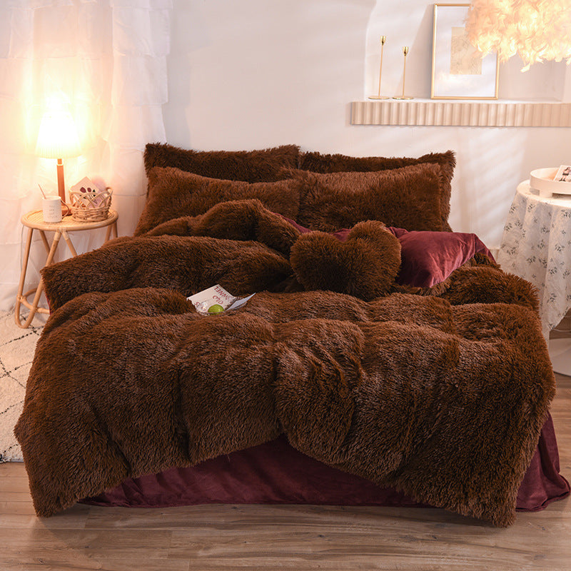 Brown fuzzy comforter set on a bed in a bedroom setting with soft lighting.