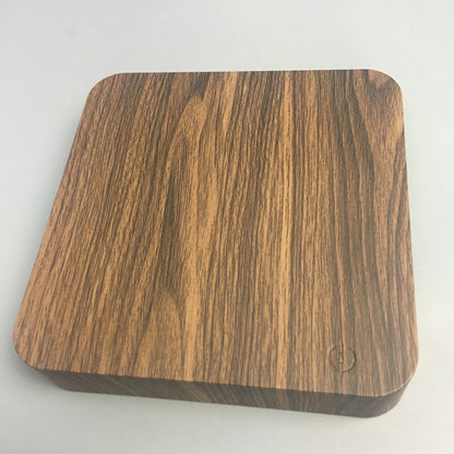 Wooden square coaster on a light gray background
