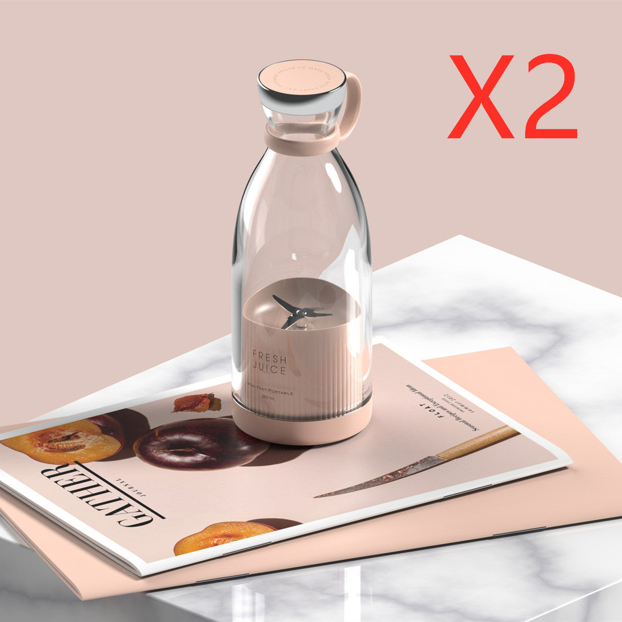 Clear glass bottle with pink base on a magazine with a beige background