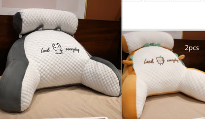 Neck pillow with 'Luck everyday' text on a bed