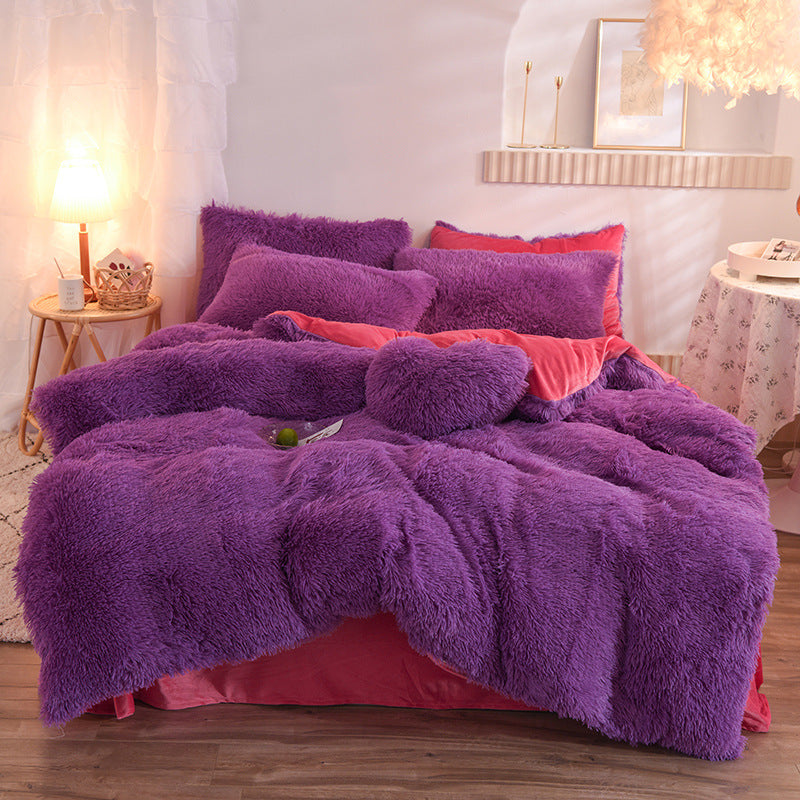 Purple fluffy comforter set on a bed in a bedroom with soft lighting.