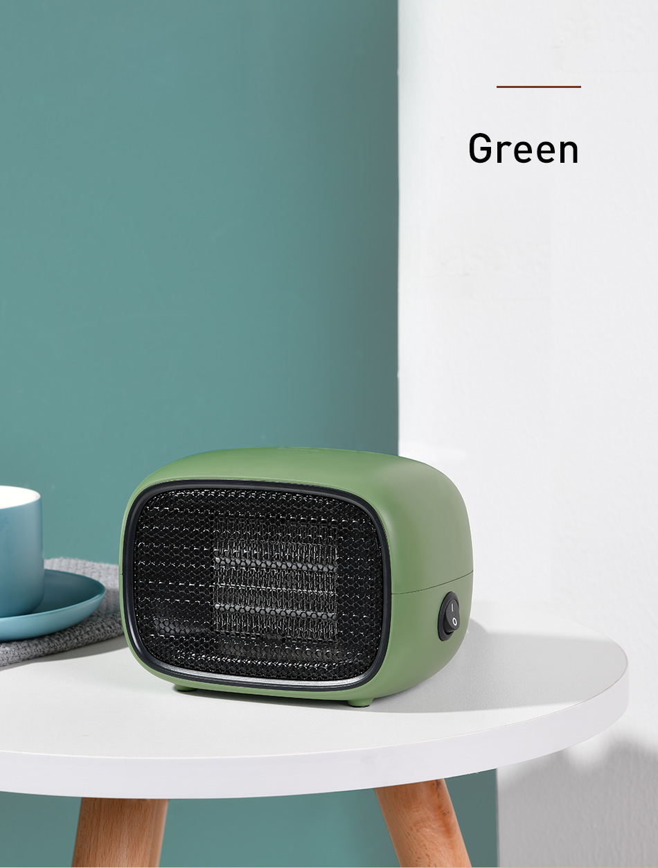 Green portable heater on a white table against a teal wall