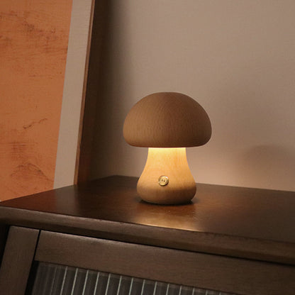 Mushroom-shaped table lamp on a wooden surface with a warm glow.