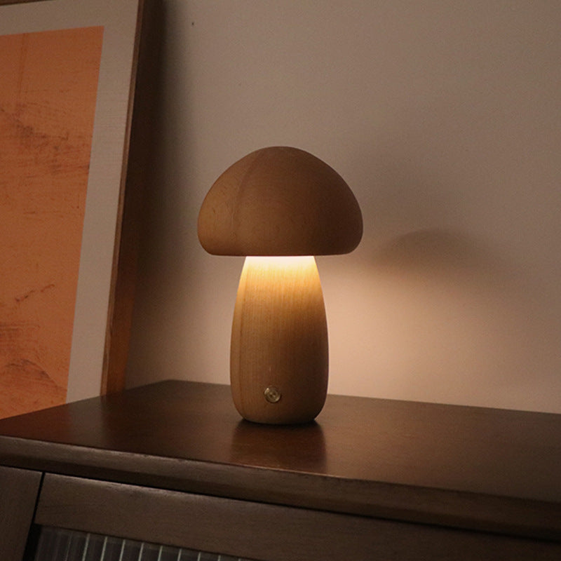 Mushroom-shaped lamp on a wooden surface with a warm glow
