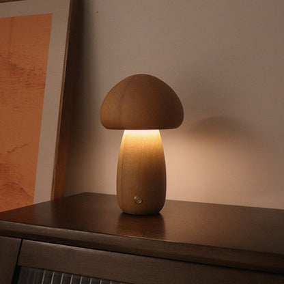 Mushroom-shaped lamp on a wooden surface with a warm glow