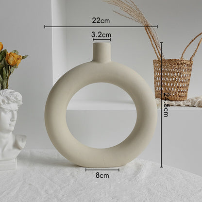 White circular vase with measurements on a light gray background