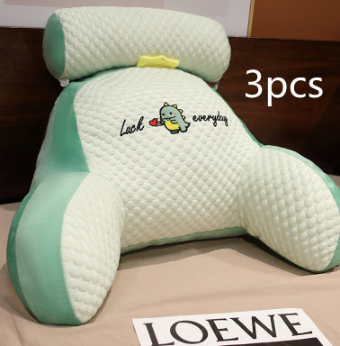 Three green and white pillows with a cartoon character on a brown surface, with 'LOEWE' branding visible.