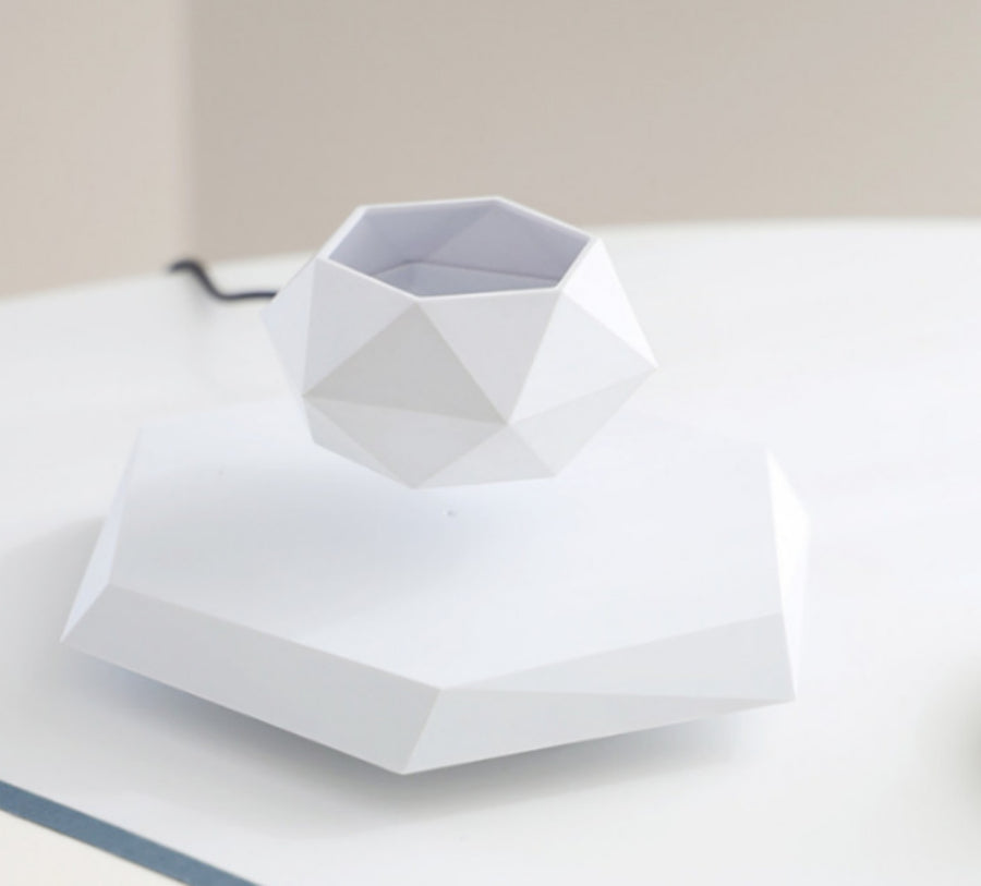 White paper folded into a shirt shape on a light surface