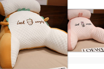 Two plush pillows with cartoon designs and text on a wooden surface.