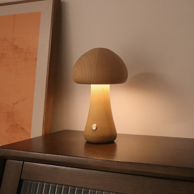 Wooden mushroom lamp on a wooden surface with a warm glow