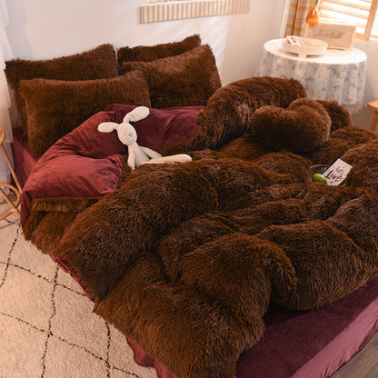 Brown fuzzy blanket draped over a bed with pillows and a stuffed animal in a bedroom setting.